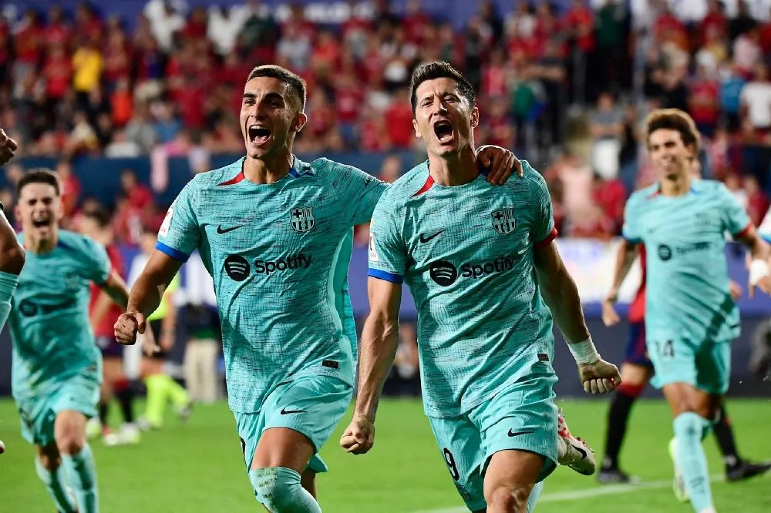 Barcelona's Spanish forward #07 Ferran Torres (L) celebrates Barcelona's Polish forward #09 Robert Lewandowski's goal scored from the penalty spot during the Spanish Liga football match between CA Osasuna and FC Barcelona at El Sadar stadium in Pamplona on September 3, 2023. (AFP) 