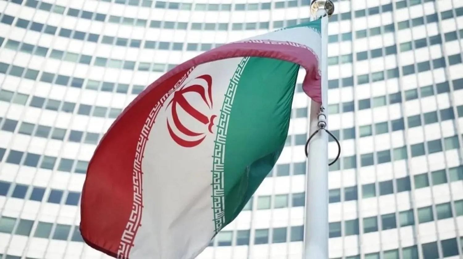 An Iranian flag waves in a wind outside the Vienna International Center hosting the United Nations (UN) headquarters and the International Atomic Energy Agency (IAEA). (AFP)