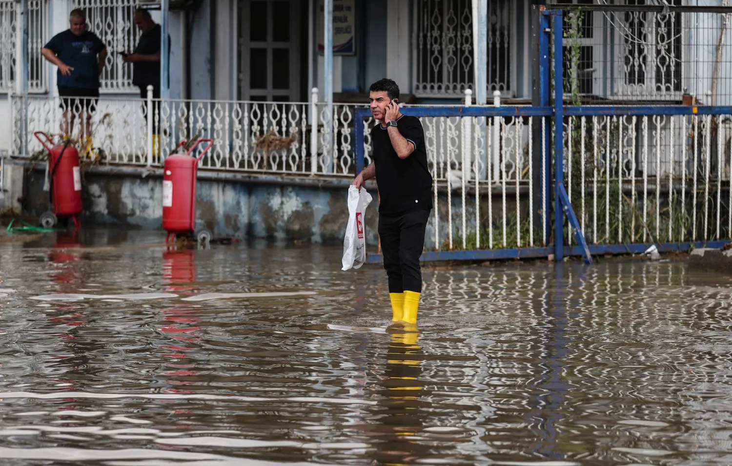 A man wades through floodwaters after floods hit the west districts of Istanbul, Türkiye, 06 September 2023. EPA/ERDEM SAHIN