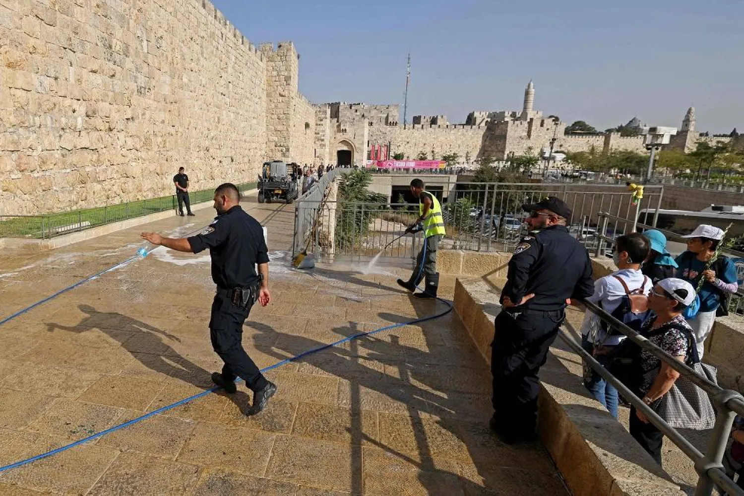  A worker cleans the scene of a stabbing attack near Jaffa Gate outside Jerusalem's Old City, September 6, 2023. (AFP) 