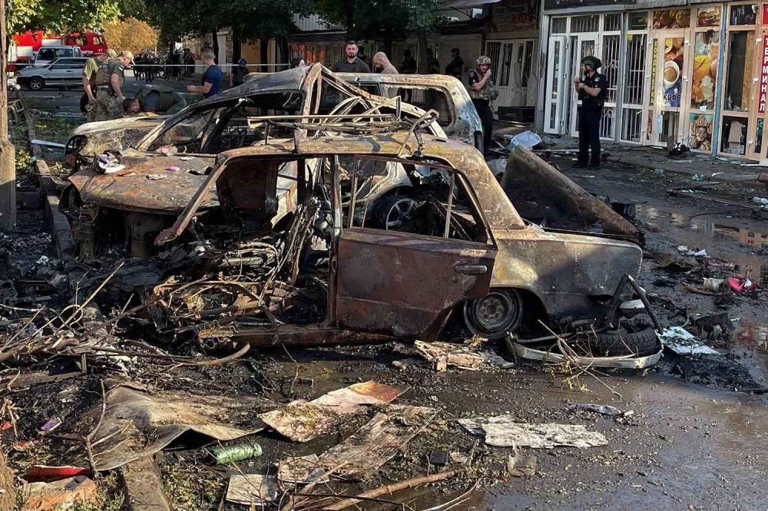 Ukrainian police and rescuers stand near car wreckages following a Russian strike in Kostyantynivka, Ukraine's eastern Donetsk region on September 6, 2023, amid the Russian invasion of Ukraine. (AFP)