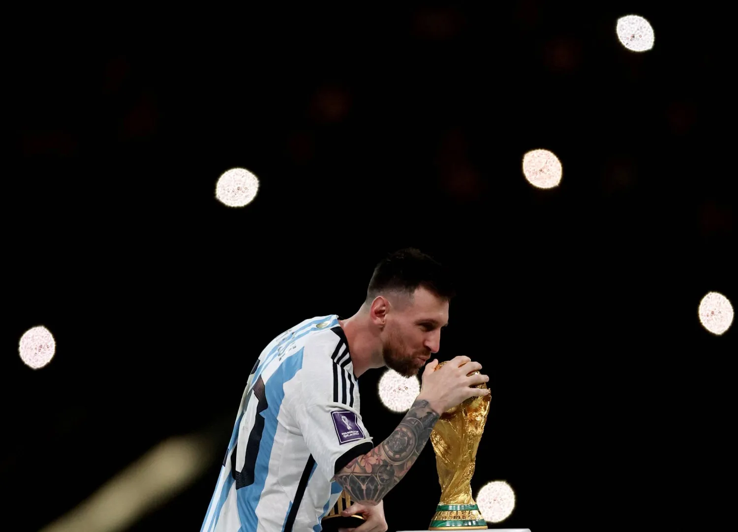 FILE PHOTO: Soccer Football - FIFA World Cup Qatar 2022 - Final - Argentina v France - Lusail Stadium, Lusail, Qatar - December 18, 2022 Argentina's Lionel Messi celebrates with the trophy after winning the World Cup REUTERS/Lee Smith/File Photo