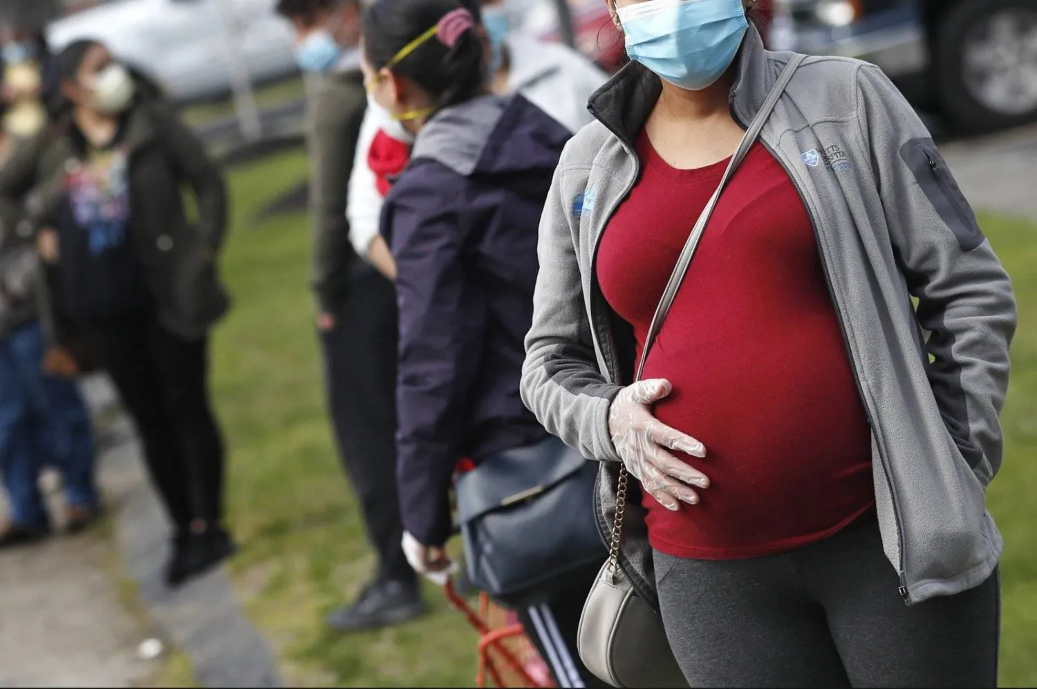 A pregnant woman waits in a food pantry line at Saint Mary'sChurch for people in need of groceries due to the COVID-19 pandemic,in Waltham, Massachusetts, US, May 7, 2020. (AP Photo)