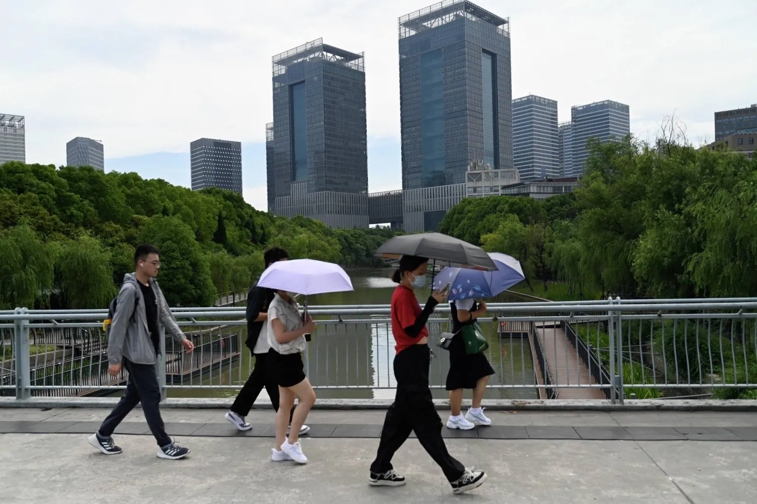 People walk on a street in Lujiazui district in Shanghai onJune 29, 2023. (PHOTO / AFP)