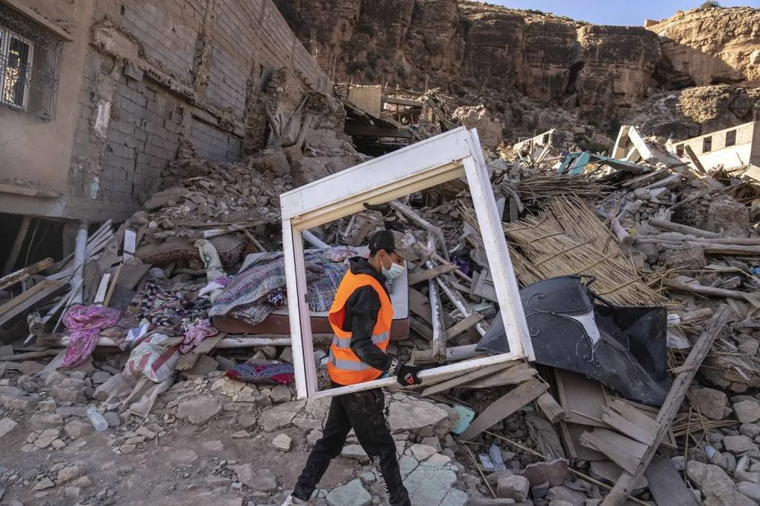 A volunteer helps salvage furniture from homes which were damaged by the earthquake, in the town of Imi N'tala, outside Marrakech, Morocco, Wednesday, Sept. 13, 2023. (AP)