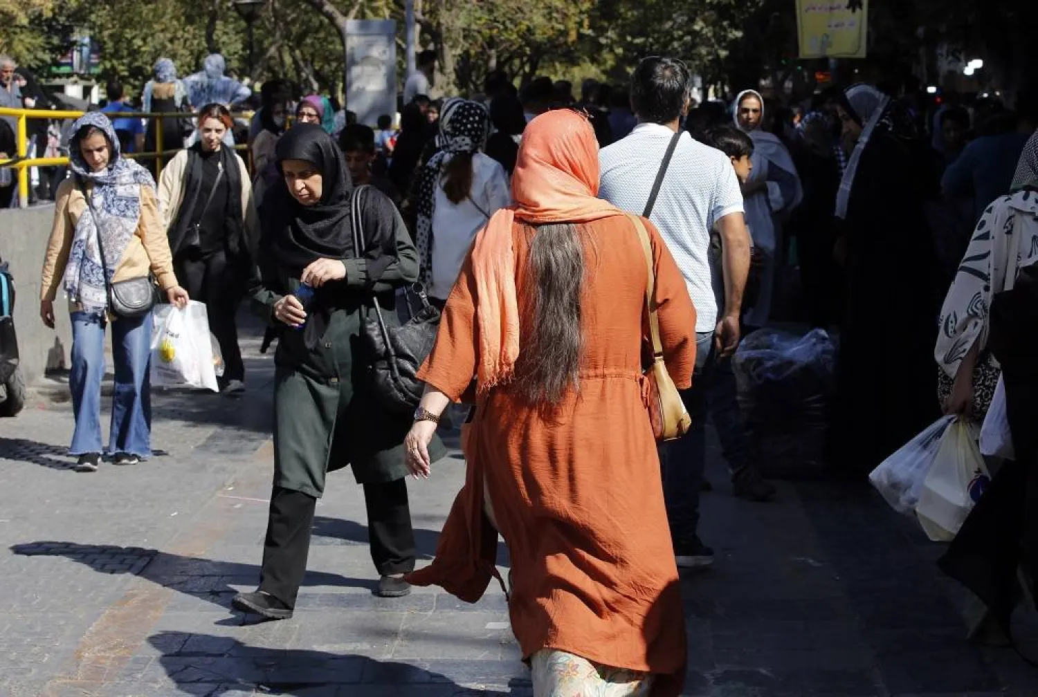 Iranian women, some without mandatory headscarf, walk in a street in Tehran, Iran, 13 September 2023. (EPA)
