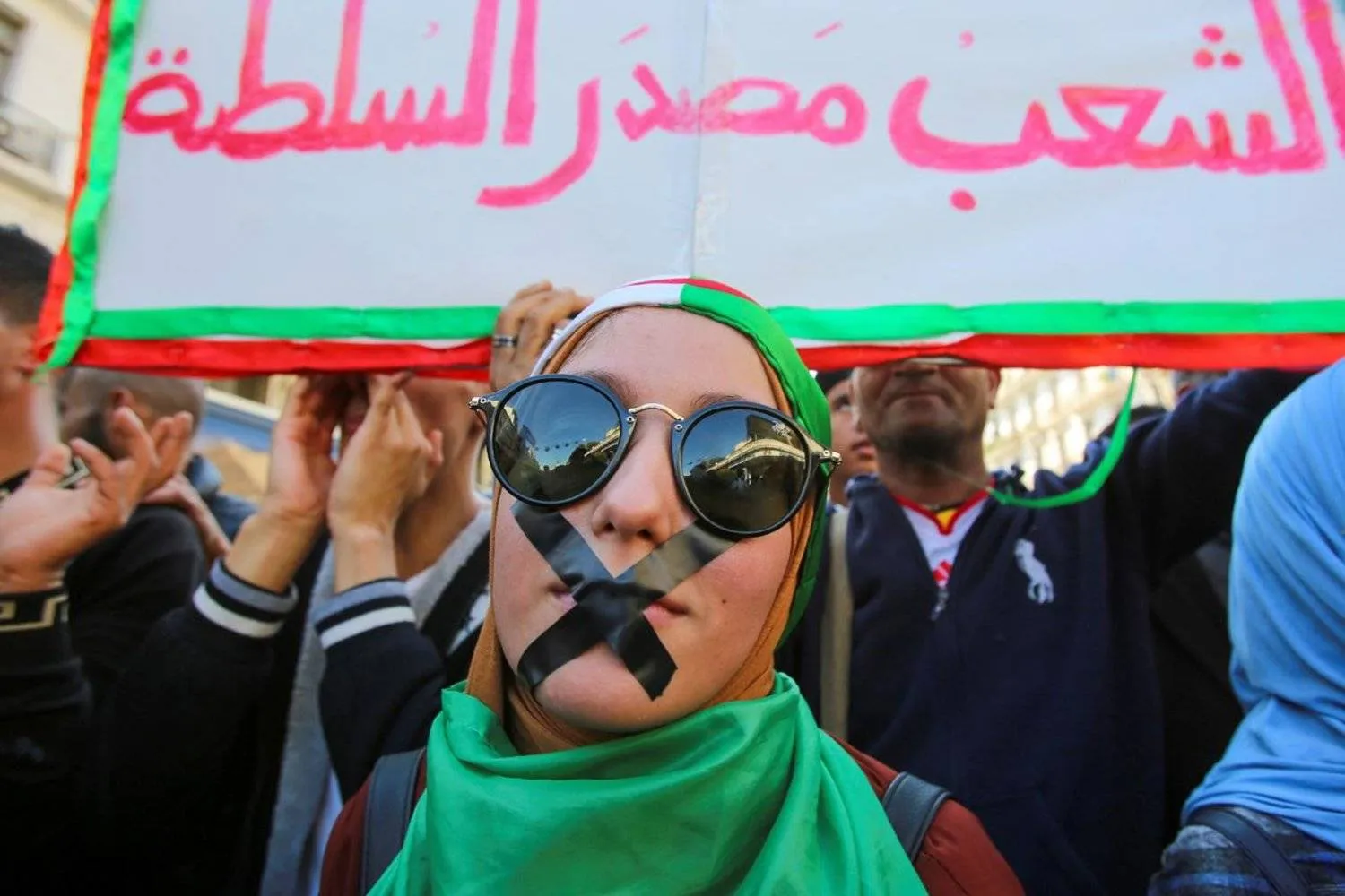 A demonstrator with tapes over her mouth takes part in a protest against the country's ruling elite and to demand an end to corruption in Algiers, Algeria October 29, 2019. (Reuters)