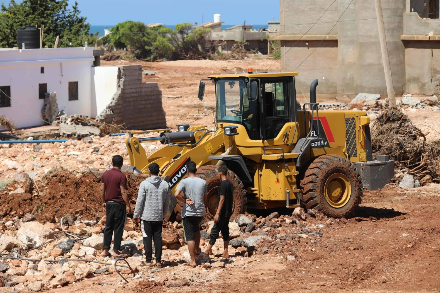  A bulldozer clears debring from the street in Libya's eastern city of Soussa on September 15, 2023, after the Mediterranean storm "Daniel". Rescuers sifted through mud and rubble on September 15 in their search for people missing from the tsunami-sized flash flood that swept the Libyan port city of Derna, killing more than 3,000. (Photo by Mohamed Shalash / AFP)