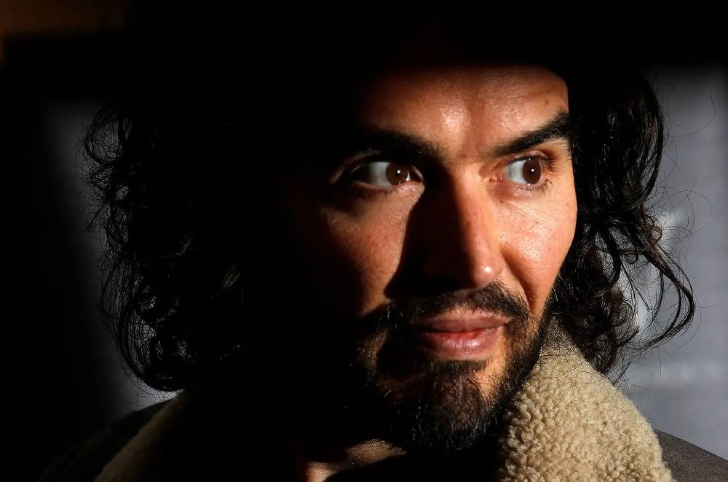 Comedian Russell Brand poses for photographers before signing copies of his new book entitled "Revolution" in central London, December 5, 2014. (Reuters)