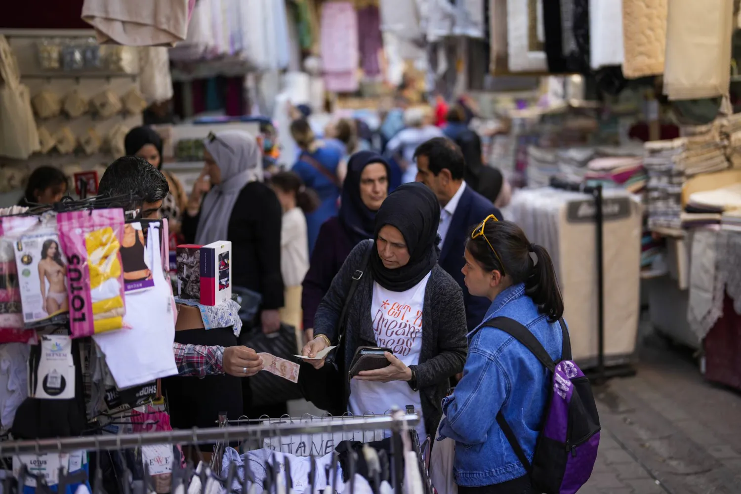 FILE - A seller attends a client in a street market at Eminonu commercial area in Istanbul, Turkey, on, June 7, 2023. (AP Photo/Francisco Seco, File)