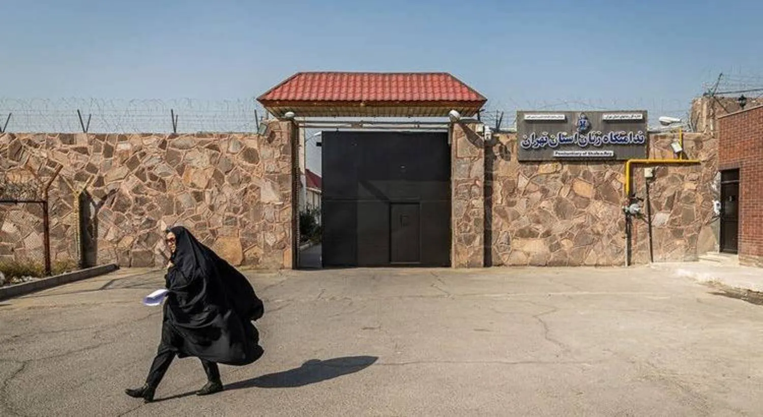An Iranian woman passes through the women’s entrance at Qarchak Prison in Tehran. (Mizan) 