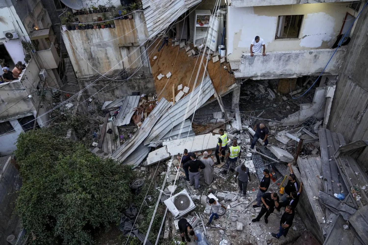 Palestinians inspect a damaged building following an Israeli army raid in Nour Shams refugee camp in the northern West Bank, Sunday, Sept. 24, 2022. (AP Photo/Majdi Mohammed)