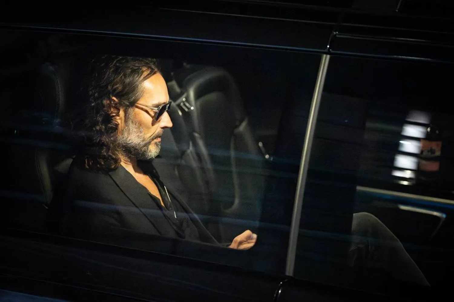 16 September 2023, United Kingdom, London: English comedian and actor Russell Brand leaves the Troubabour Wembley Park theater in north-west London after performing a comedy set. (dpa)