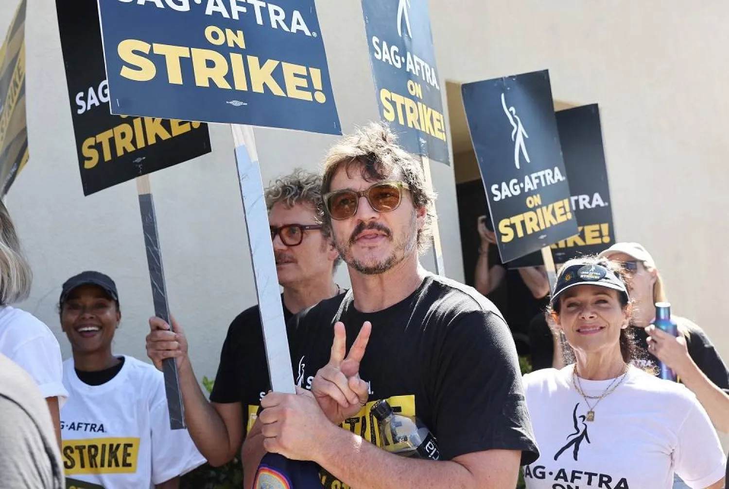 Pedro Pascal (C) walks the picket line with striking SAG-AFTRA members outside Warner Bros. Studio as the actors strike continues on September 26, 2023 in Burbank, California. (Getty Images via AFP)