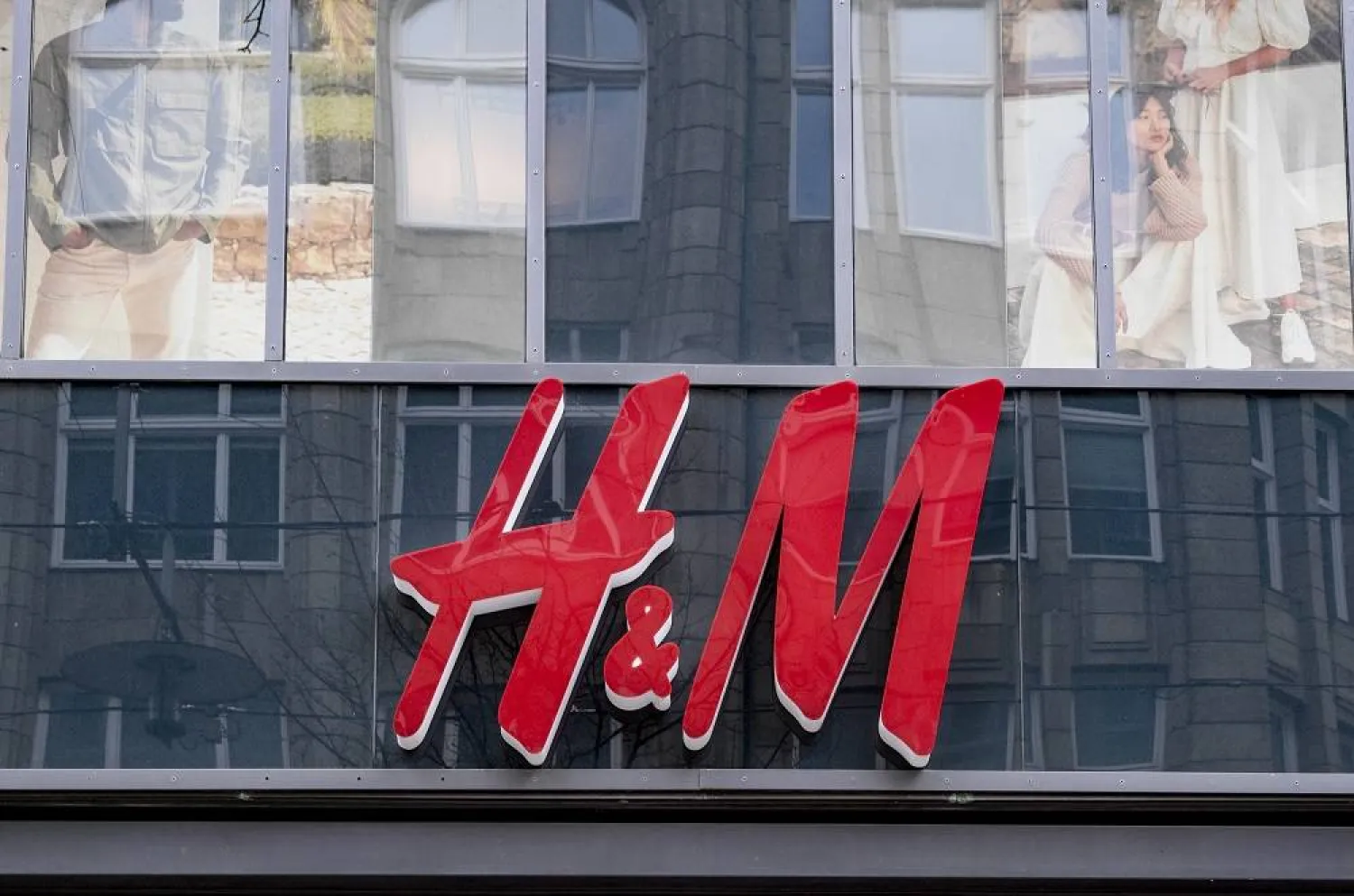 01 April 2020, Hamburg: The logo of the H&M fashion chain hangs above the entrance of the department store in downtown Hamburg. (dpa) 