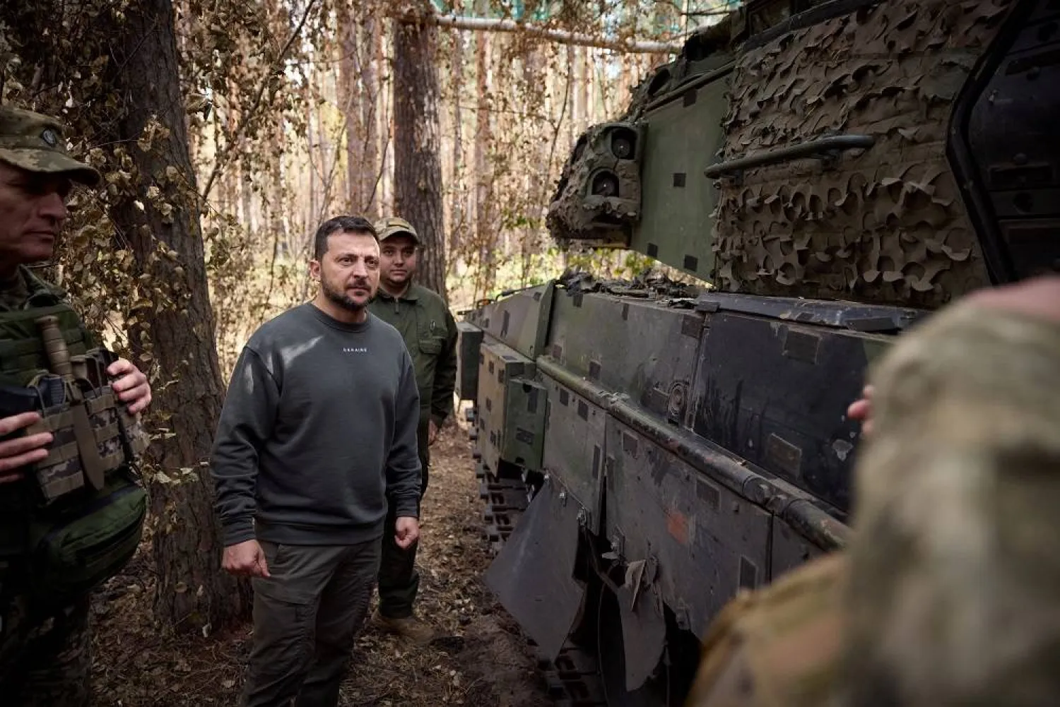 Ukraine's President Volodymyr Zelenskiy stands next to a Swedish CV90 armored fighting vehicle as he visits a position of Ukrainian troops in a front line, amid Russia's attack on Ukraine, in an undisclosed location, Ukraine October 3, 2023. (Ukrainian Presidential Press Service/Handout via Reuters) 