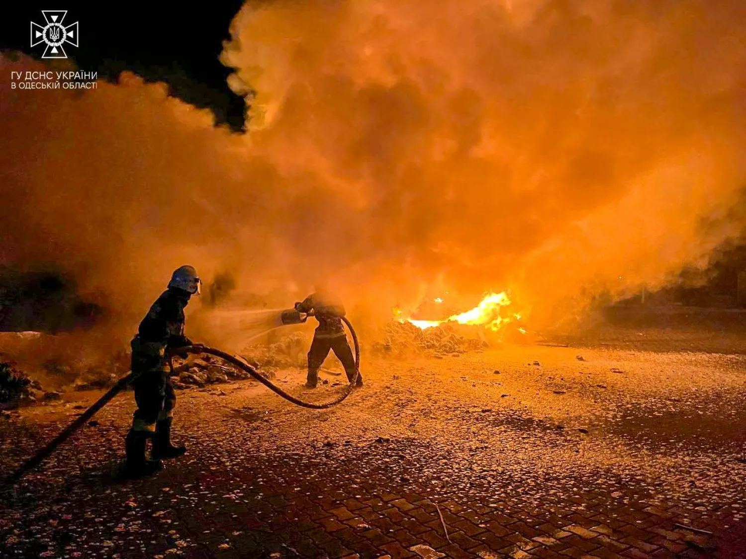 Firefighters extinguish burning trucks damaged during a Russian drone attack, amid Russia's attack on Ukraine, at a compound of a port on Danube river in Odesa region, Ukraine September 26, 2023. Press service of a State Emergency Service of Ukraine in Odesa region/Handout via REUTERS