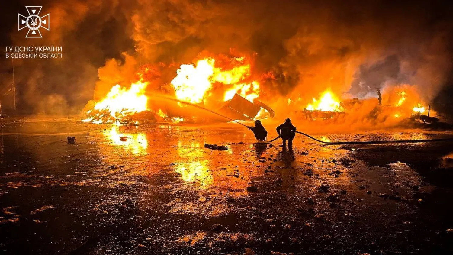 This handout photograph taken and released by Ukrainian emergency service on October 6, 2023, shows firefighters working to extinguish a fire on the port infrastructure on the Danube river, in the Odesa region, amid the Russian invasion in Ukraine. (Photo by Handout / AFP) / 