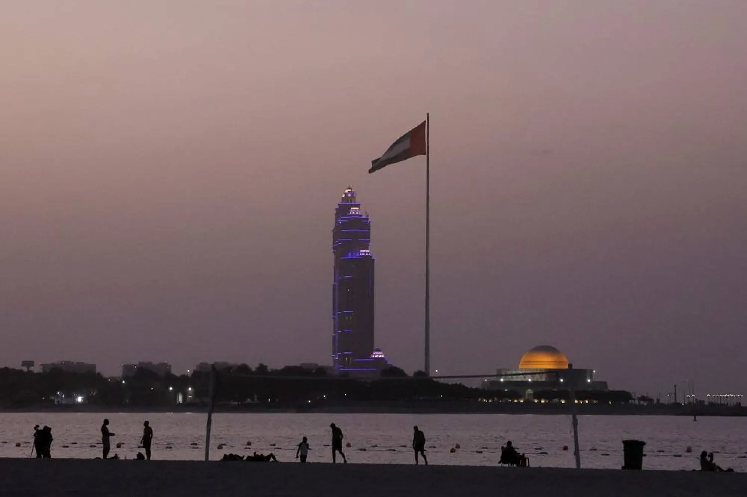  People enjoy after the sunset in a beach in Abu Dhabi, United Arab Emirates, September 27, 2023. (Reuters)