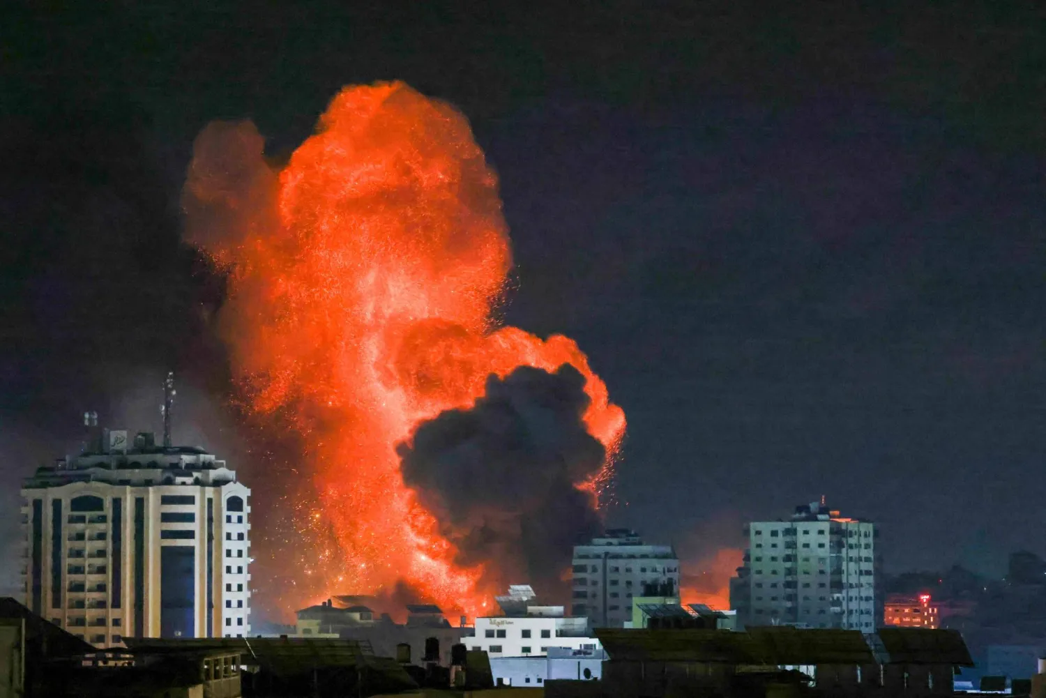 A fireball erupts from an Israeli airstrike in Gaza City on October 9, 2023. (Photo by MOHAMMED ABED / AFP)

