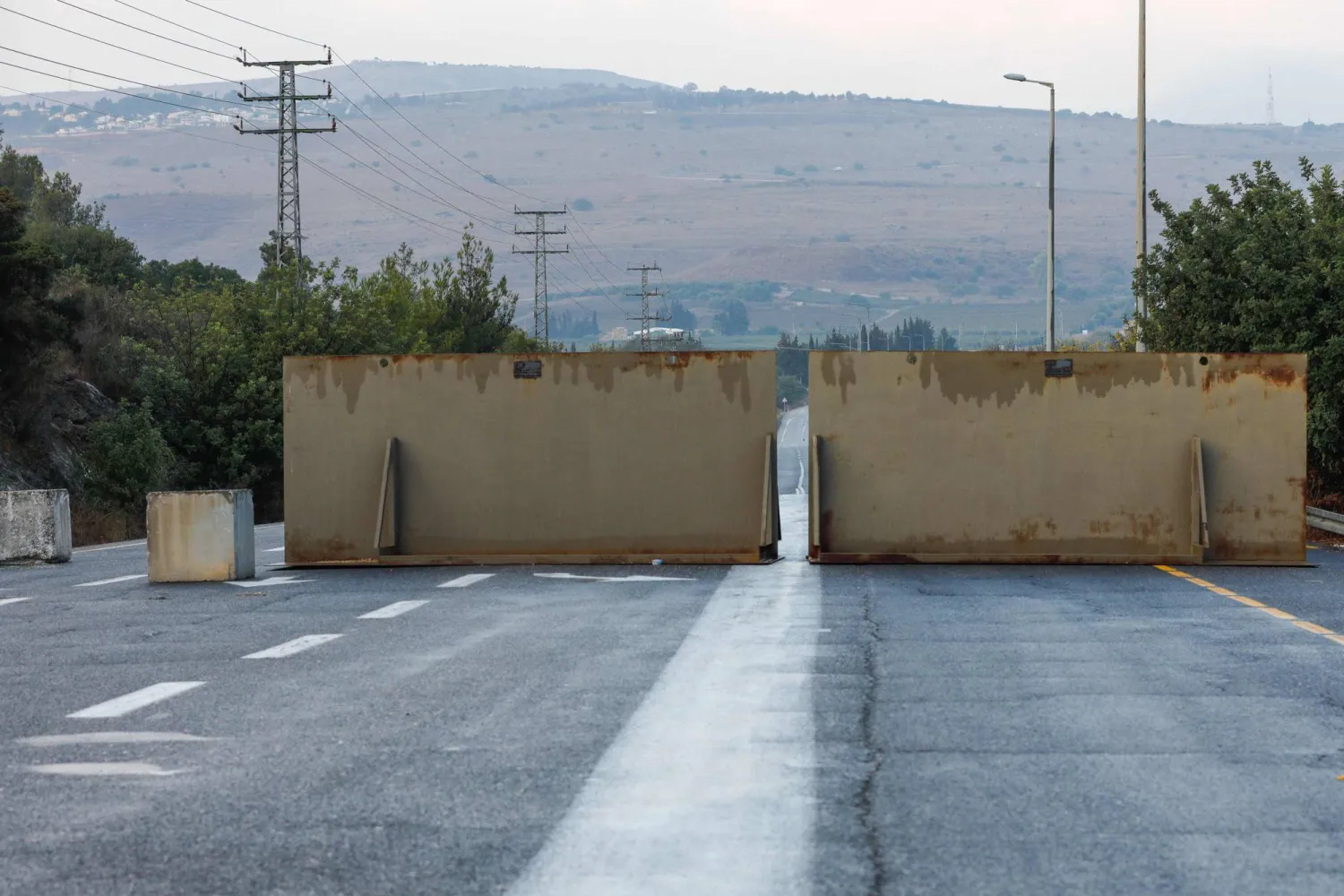 Iron barriers set-up by the Israeli army block one of the northern roads near the Yiftah kibbutz near the border with Lebanon on October 10, 2023. - Reuters