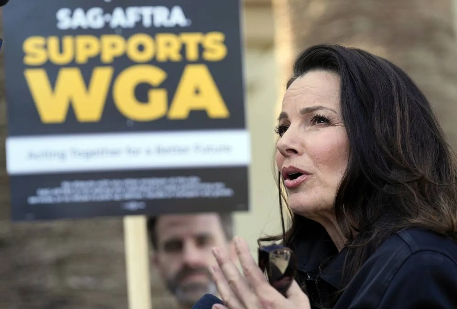 Fran Drescher, president of SAG-AFTRA, is interviewed at a Writers Guild of America rally outside Paramount Pictures studio on May 8, 2023, in Los Angeles. (AP)