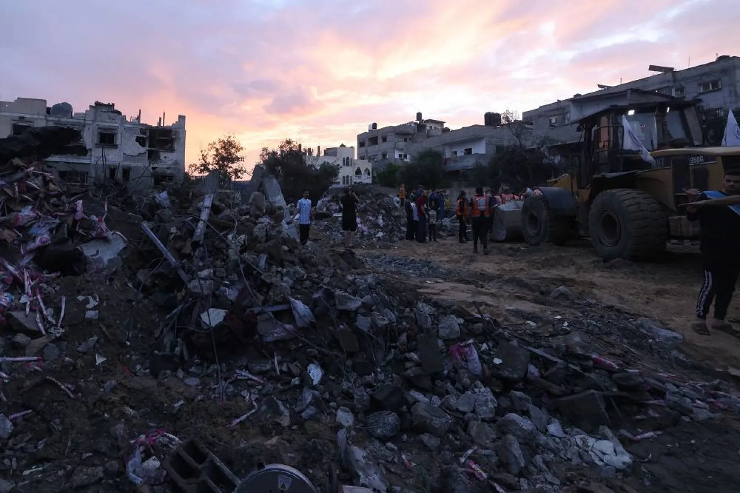 Palestinians search for survivors amidst the rubble of a building after an Israeli airstrike on the Rafah refugee camp, in the southern Gaza Strip on October 17, 2023. (AFP)