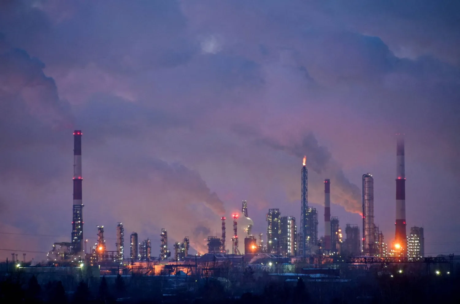 FILE PHOTO: Flue gas and steam rise out of chimneys and smokestacks of an oil refinery during sunset on a frosty day in the Siberian city of Omsk, Russia, February 8, 2023. REUTERS/Alexey Malgavko//File Photo