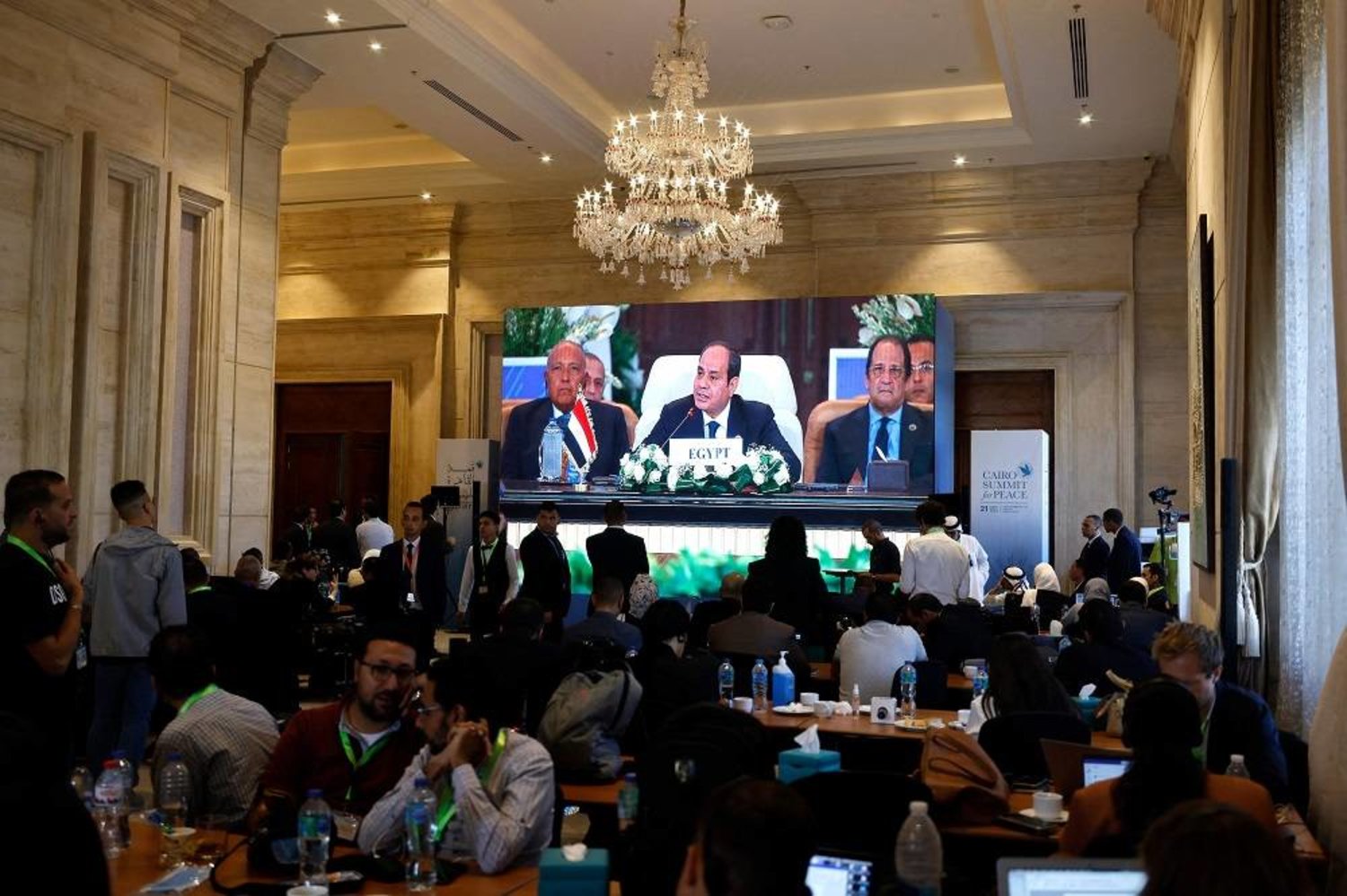 Seen on a large screen the Egyptian President Abdel-Fattah al-Sisi opens the International Peace Summit in Cairo on October 21, 2023, amid the ongoing battles between Israel and the Palestinian group Hamas. (AFP) 