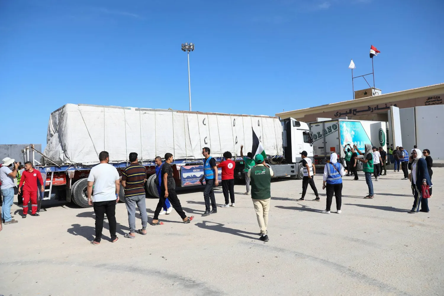 Trucks carrying humanitarian aid drive through the Rafah crossing from the Egyptian side, amid the ongoing conflict between Israel and the Palestinian group Hamas, in Rafah, Egypt October 21, 2023. REUTERS/Stringer