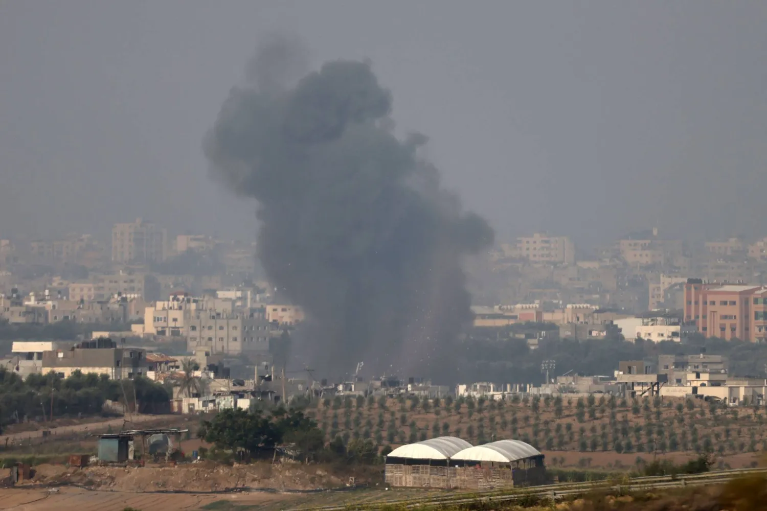 This picture taken from Israel's southern city of Sderot shows smoke billowing over the northern Gaza Strip during Israeli bombardment on October 22, 2023. (Photo by JACK GUEZ / AFP)