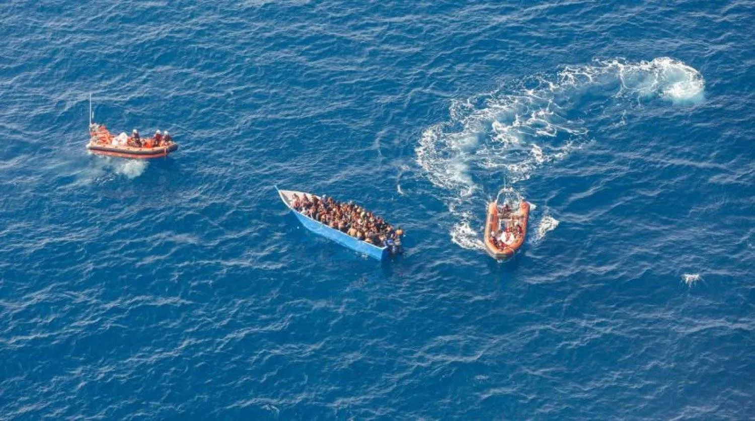 File photo: Members of the German charity Sea-Watch 3 rescue ship team help migrants on a wood boat during a rescue operation in the Mediterranean Sea, February 26, 2021. Selene Magnolia/Sea-Watch/Handout via REUTERS
