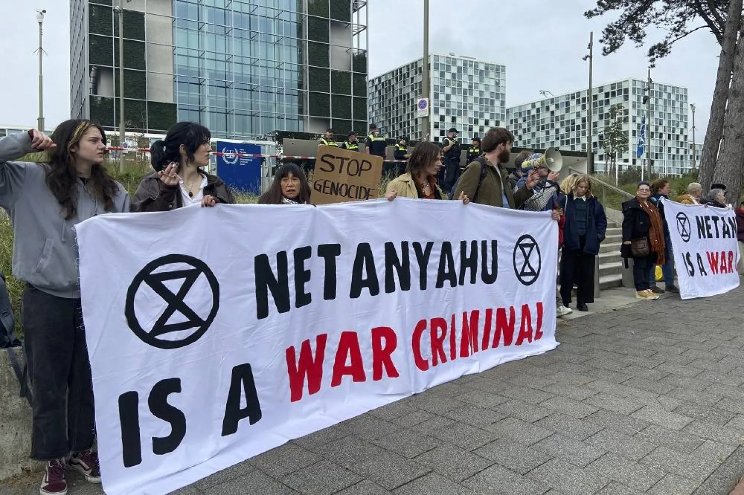 Activists hold up a banner denouncing Israeli Prime Minister Benjamin Netanyahu for Israel’s actions during the war with Hamas as they demonstrate at the entrance of the International Criminal Court in The Hague, Netherlands, Monday, Oct. 23, 2023. (AP)
