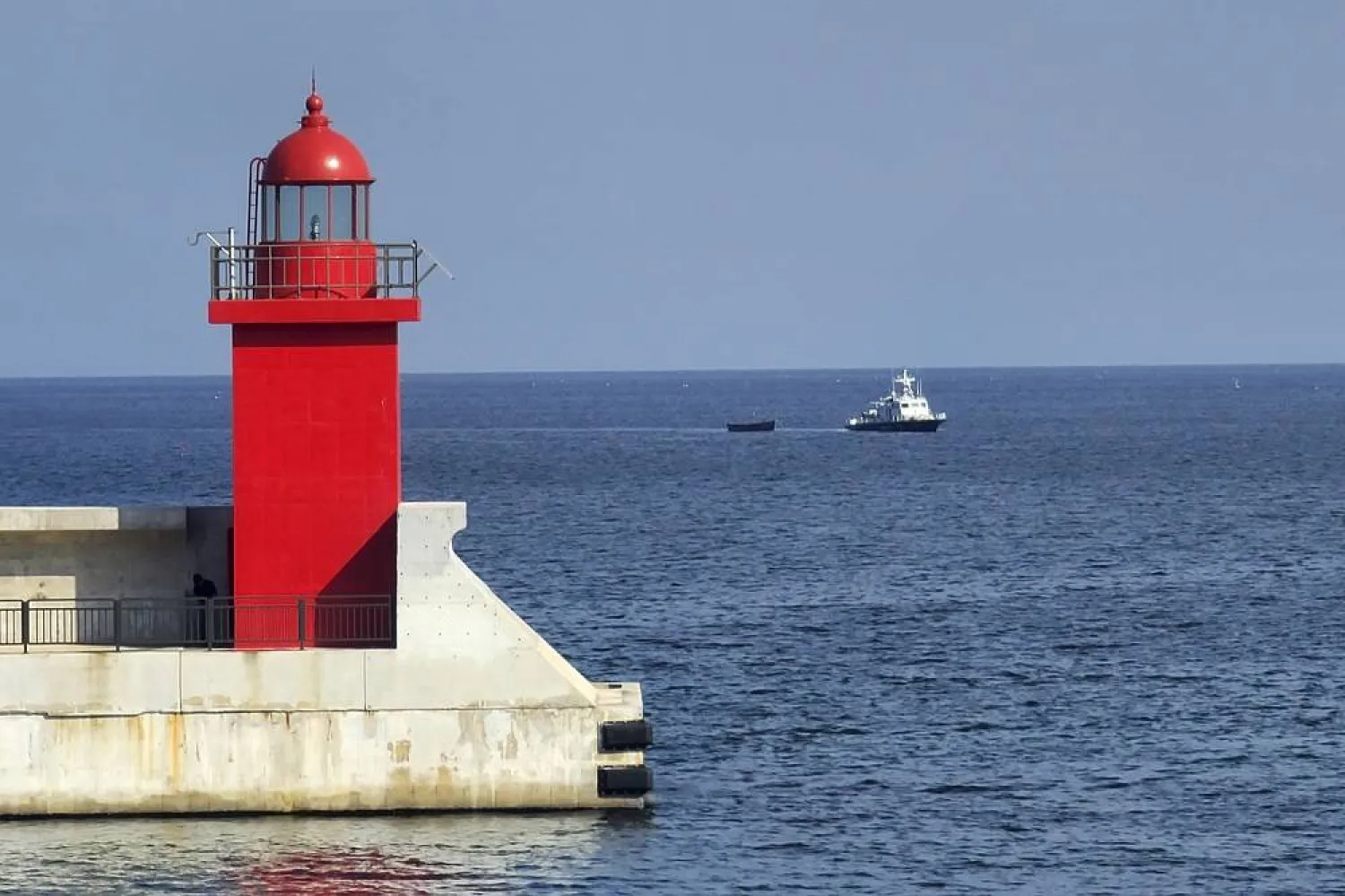 A small wooden boat, center, is towed into a port in Yangyang, South Korea, Tuesday, Oct. 24, 2023. (Yonhap via AP)
