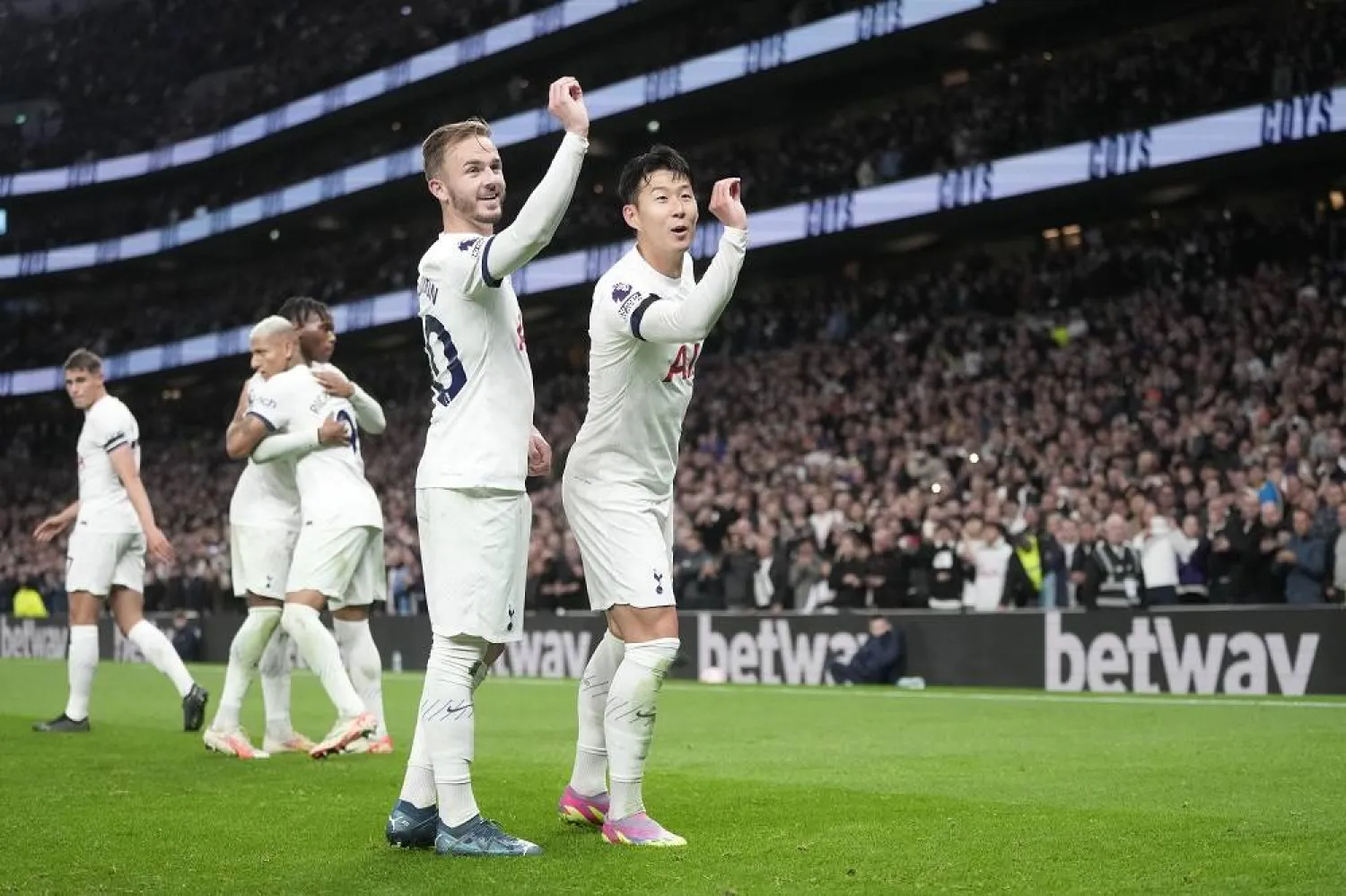 Tottenham's James Maddison, center, celebrates with Tottenham's Son Heung-min after scoring his side's second goal during the English Premier League match between Tottenham Hotspur and Fulham at the Tottenham Hotspur Stadium in London, Monday, Oct. 23, 2023. (AP)