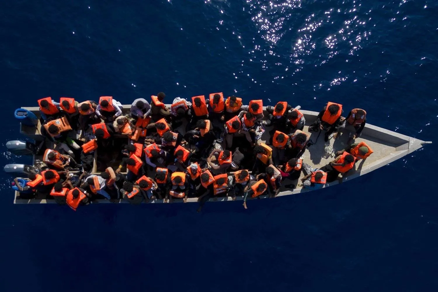 Migrants are seen on a boat in the Mediterranean Sea. AP