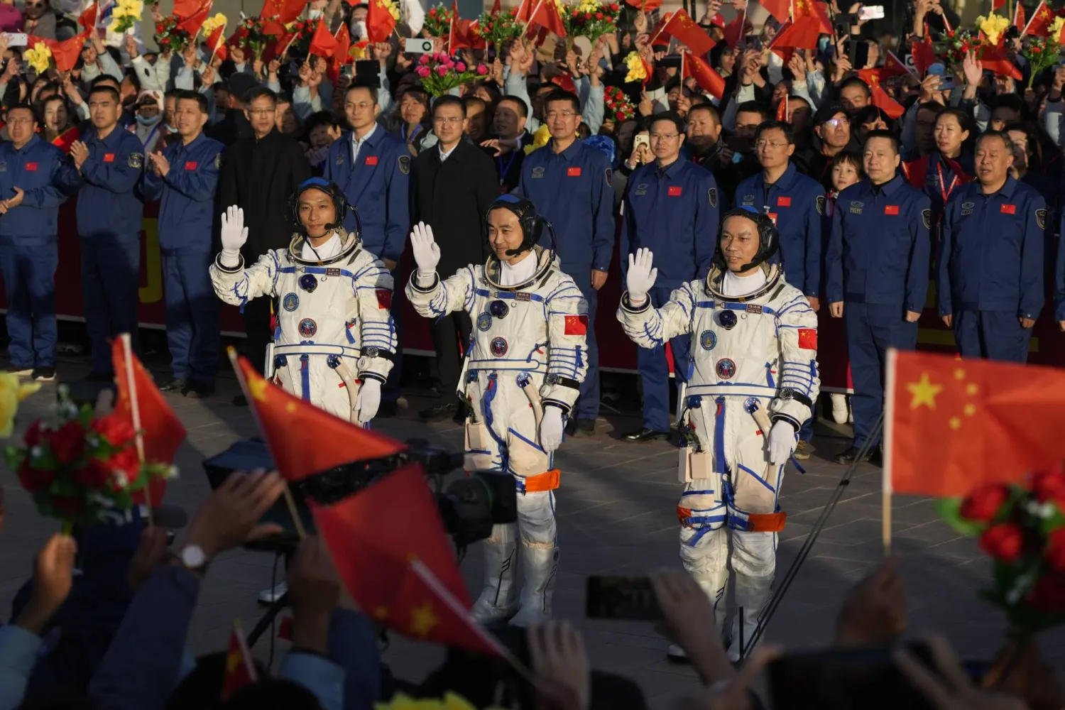 Chinese astronauts for the Shenzhou-17 mission, from left, Jiang Xinlin, Tang Hongbo and Tang Shengjie wave as they attend a send-off ceremony for their manned space mission at the Jiuquan Satellite Launch Center in northwestern China, Thursday, Oct. 26, 2023. (AP Photo/Andy Wong)