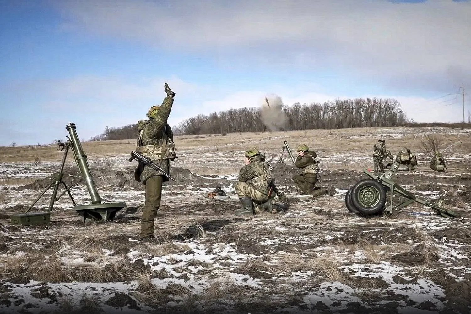 In this handout photo taken from video and released by Russian Defense Ministry Press Service on Friday, Feb. 17, 2023, the Russian army's 120 mm mortars fire at Ukrainian troops at an undisclosed location. (Russian Defense Ministry Press Service via AP)