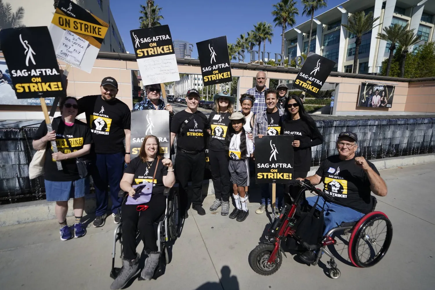 A group of Performers with Disabilities (PWD) pose for pictures as they join SAG-AFTRA picketers outside Fox Studios in Los Angeles, Thursday, Oct. 26, 2023. (AP Photo/Damian Dovarganes)