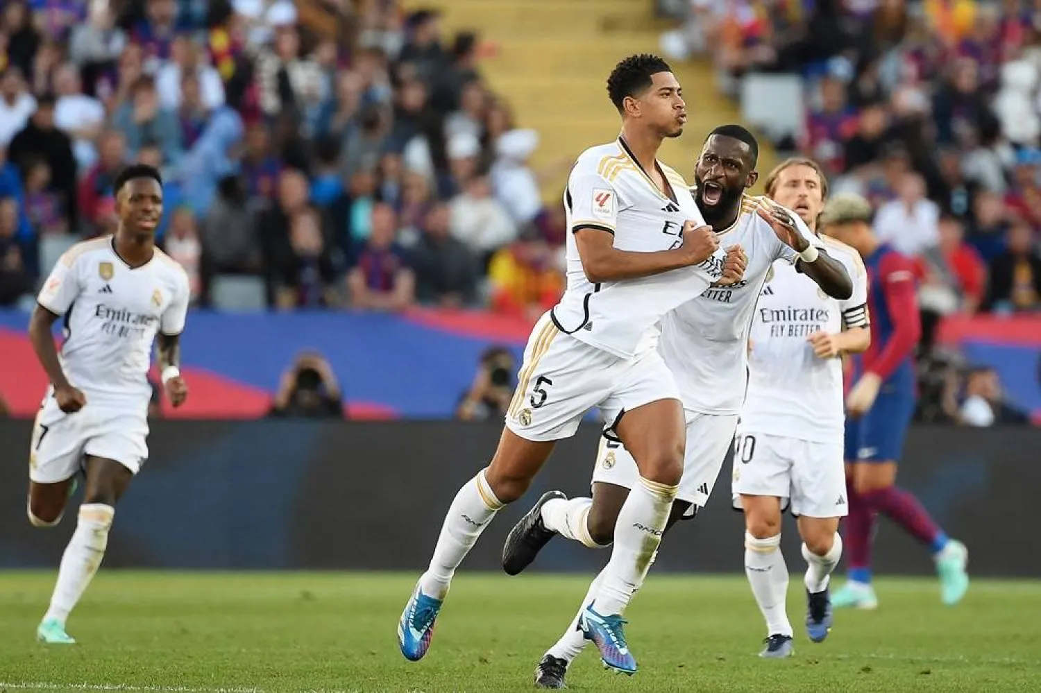  Real Madrid's English midfielder #5 Jude Bellingham celebrates with Real Madrid's German defender #22 Antonio Rudiger after scoring a goal during the Spanish league football match between FC Barcelona and Real Madrid CF at the Estadi Olimpic Lluis Companys in Barcelona on October 28, 2023. (AFP) 