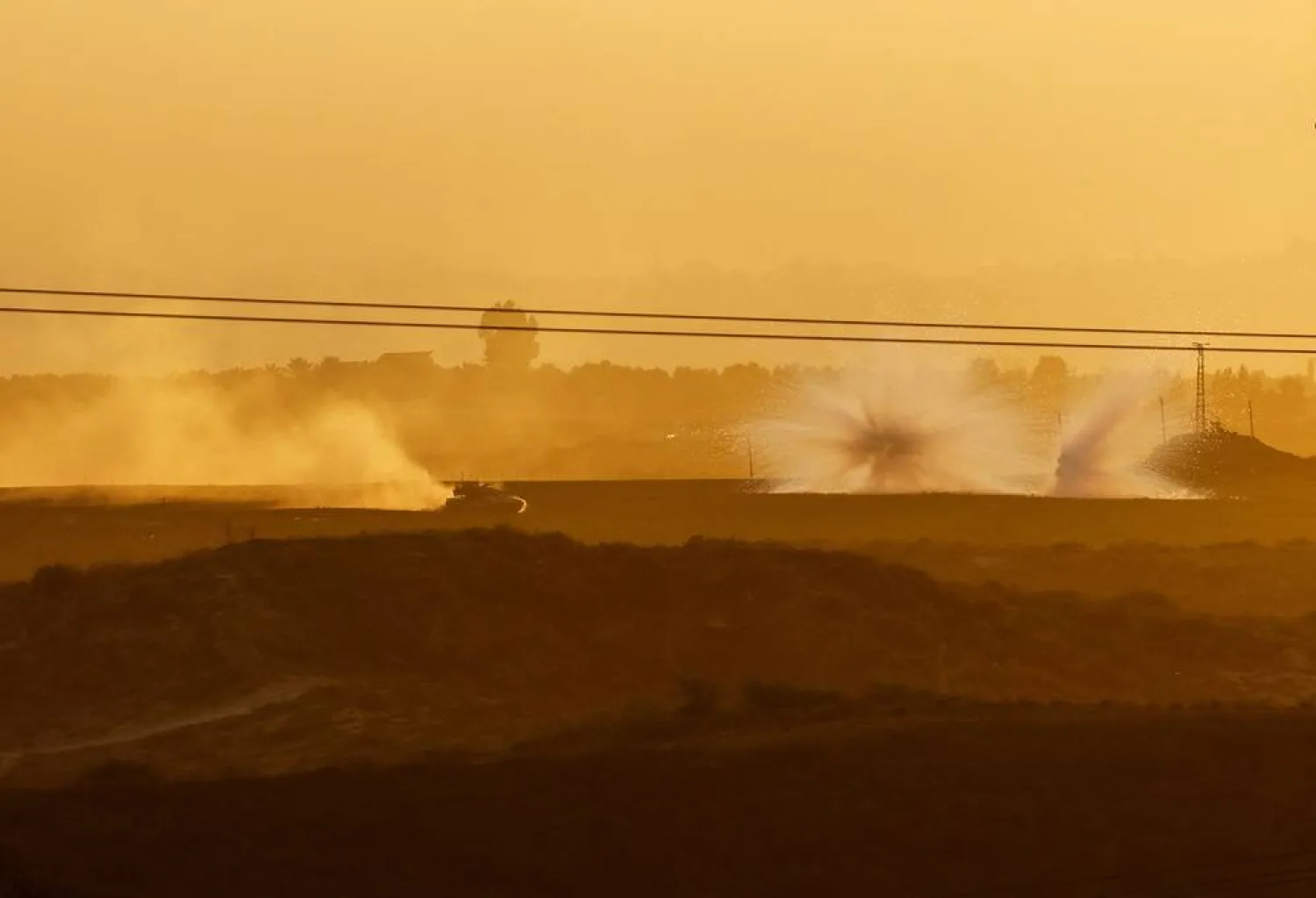  An Israeli tank maneuvers and explosions can be seen inside the Gaza Strip, as seen from Israel, October 29, 2023. (Reuters)