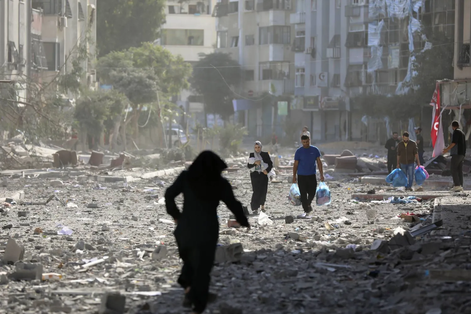 Palestinians leave their homes following an Israeli bombardment on Gaza City, Monday, Oct. 30, 2023. (AP Photo/Abed Khaled)