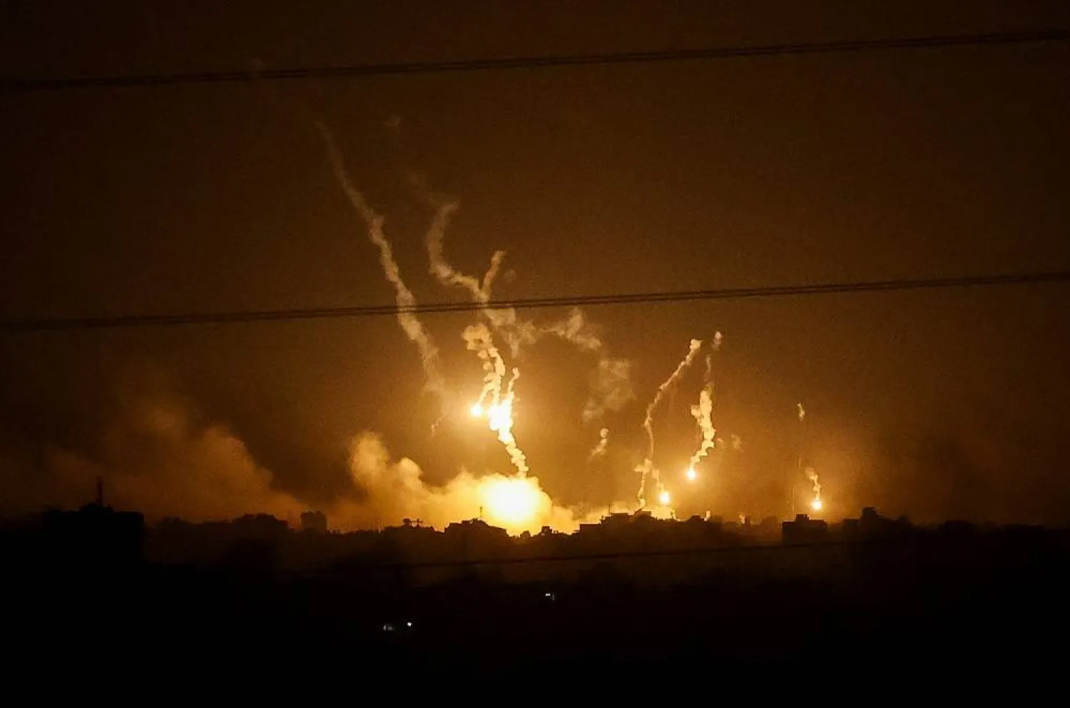 Flares burn in the sky as seen from the Israeli side of the border with Gaza, in southern Israel, November 5, 2023. (Reuters)