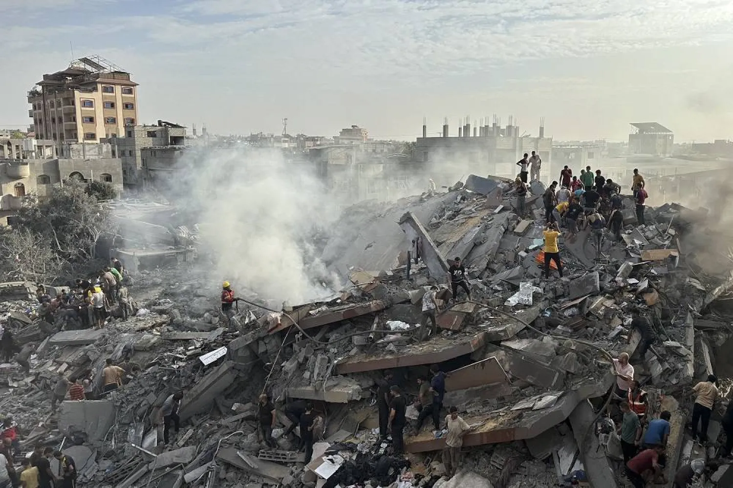 Palestinians look for survivors following Israeli airstrike in Nusseirat refugee camp, Gaza Strip, Oct. 31, 2023. (AP)