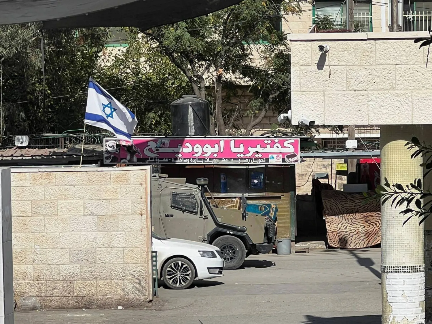 An Israeli army vehicle is seen in front of a hospital during an Israeli raid in Jenin in the Israeli-occupied West Bank November 9,2023. REUTERS/Raneen Sawafta