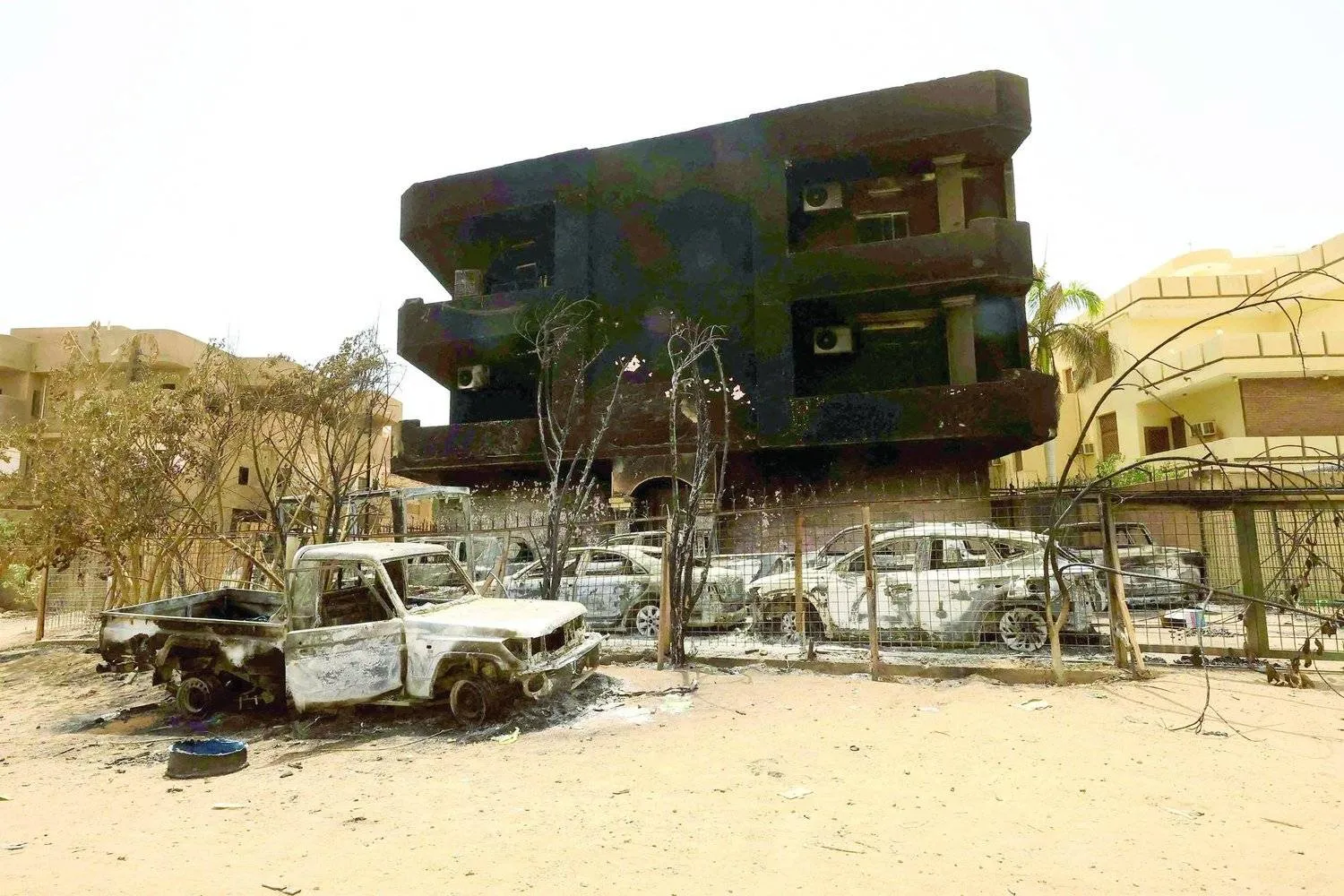 سيارات ومبانٍ مدمَّرة في السوق المركزية شمال الخرطوم (رويترز)