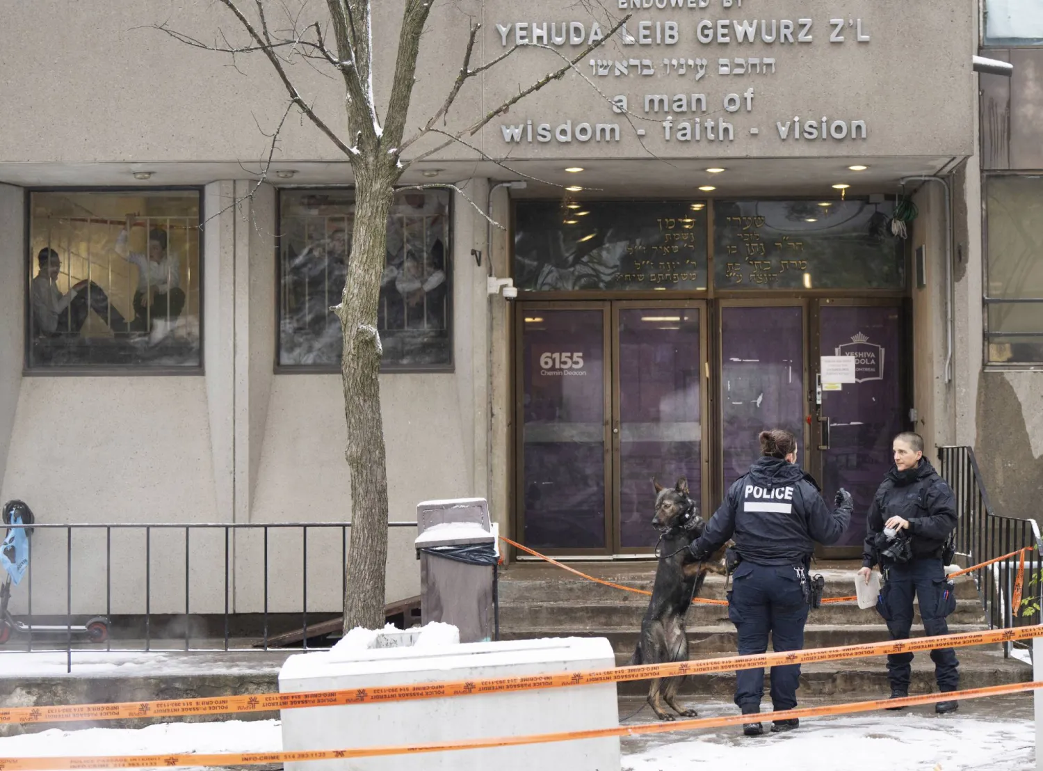 Police investigate the Yeshiva Gedolah school for clues after shots were fired, Thursday, Nov. 9, 2023 in Montreal. (Ryan Remiorz/The Canadian Press via AP)