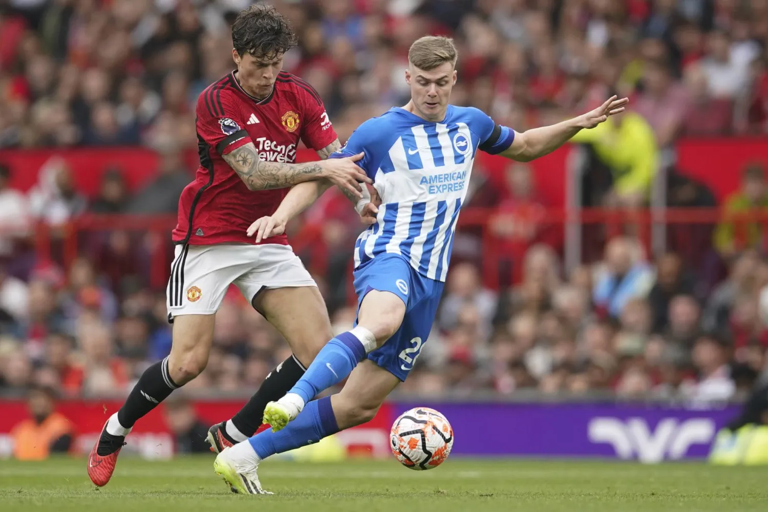FILE - Manchester United's Victor Lindelof, left, challenges Brighton's Evan Ferguson during the English Premier League soccer match between Manchester United and Brighton and Hove Albion at Old Trafford stadium in Manchester, England, on Sept. 16, 2023. (AP Photo/Dave Thompson, File)