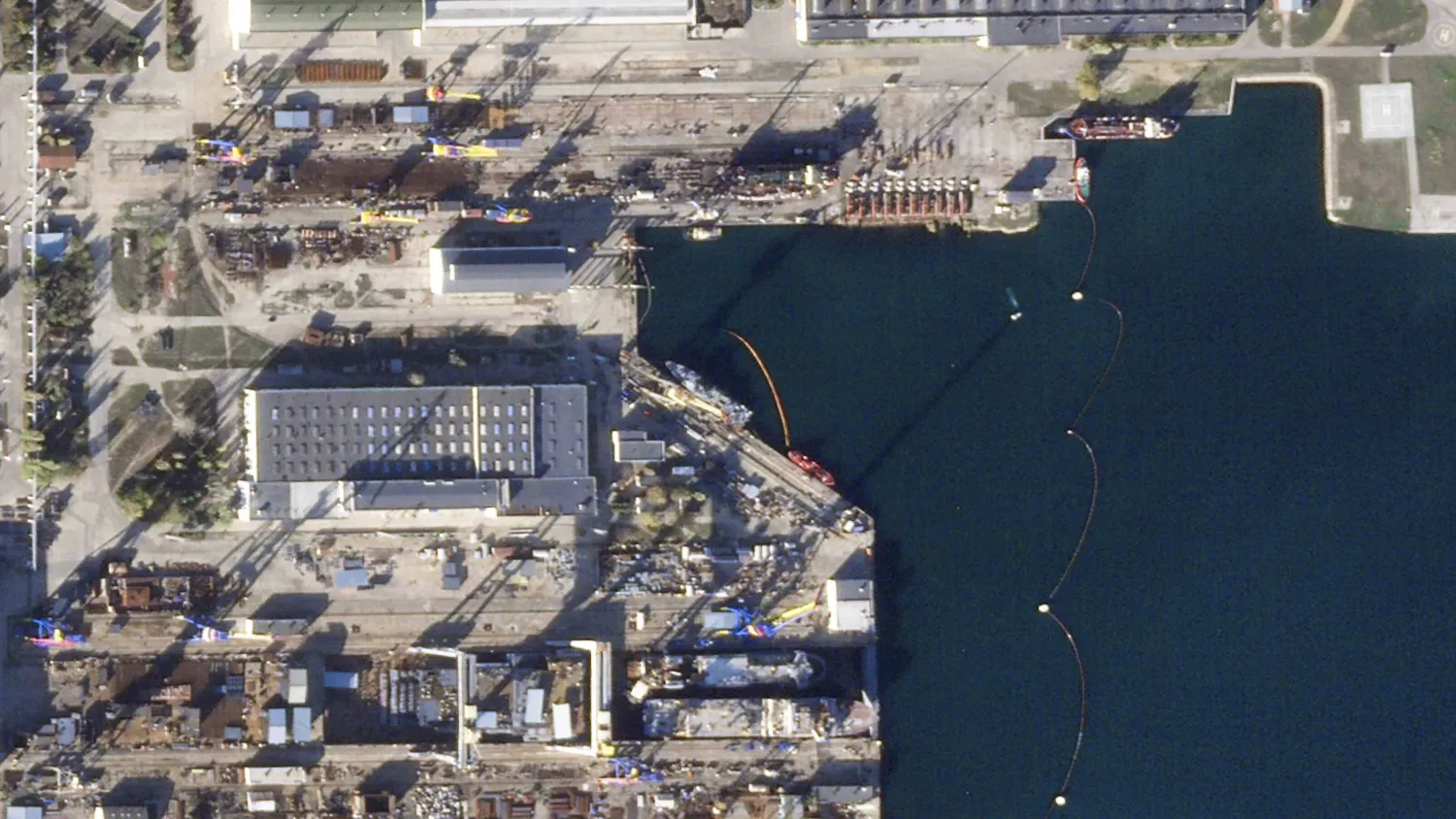 This satellite image from Planet Labs PBC shows a shipyard in Kerch in the Crimean Peninsula after a Ukrainian missile attack targeted the shipyard and a Russian naval vessel there Sunday, Nov. 5, 2023. (Planet Labs PBC via AP)