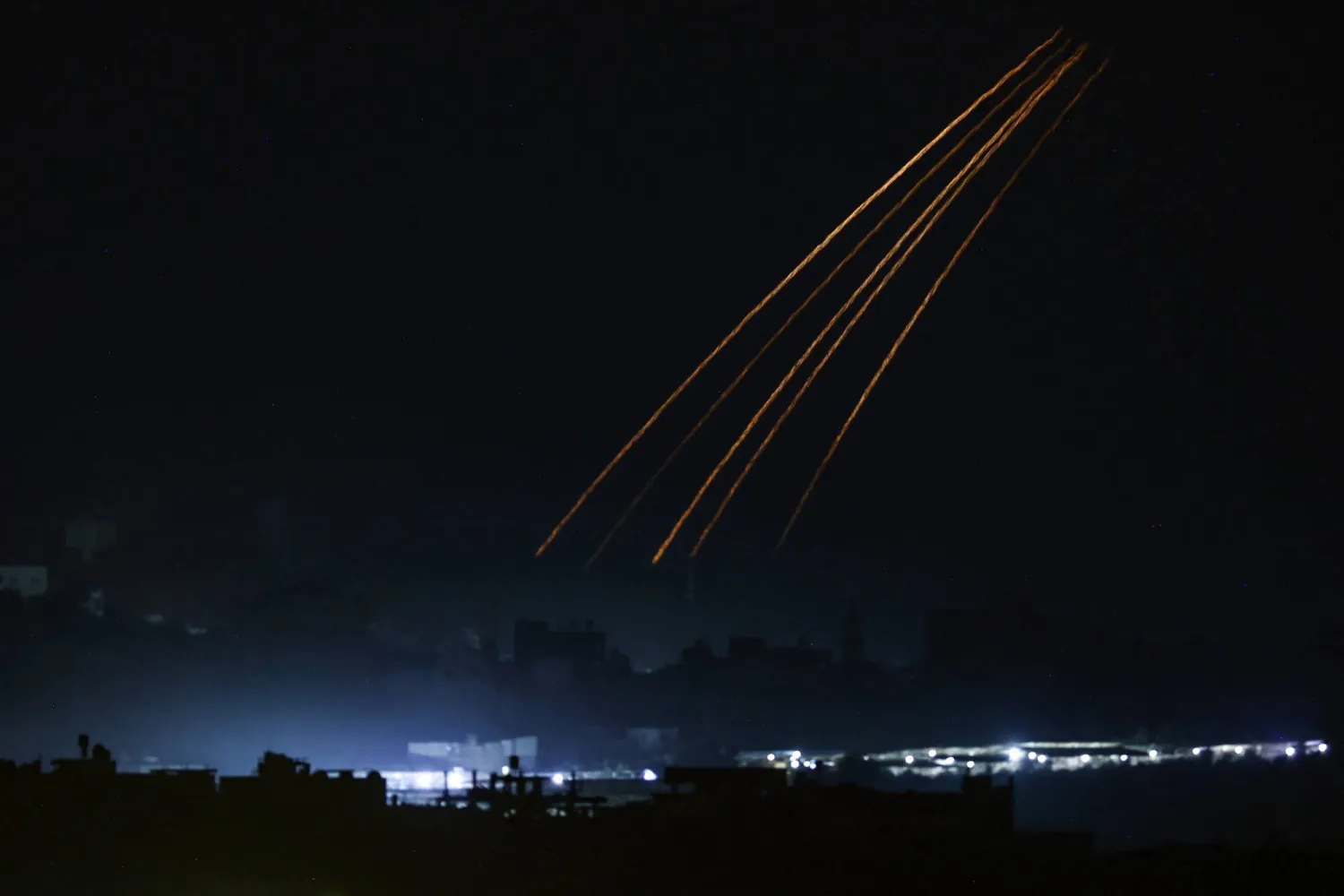This picture taken from the Israeli side of the border with Gaza on November 10, 2023, shows Israeli flares over the Gaza Strip amid ongoing battles between Israel and the Palestinian Hamas movement. (Photo by Kenzo TRIBOUILLARD / AFP)